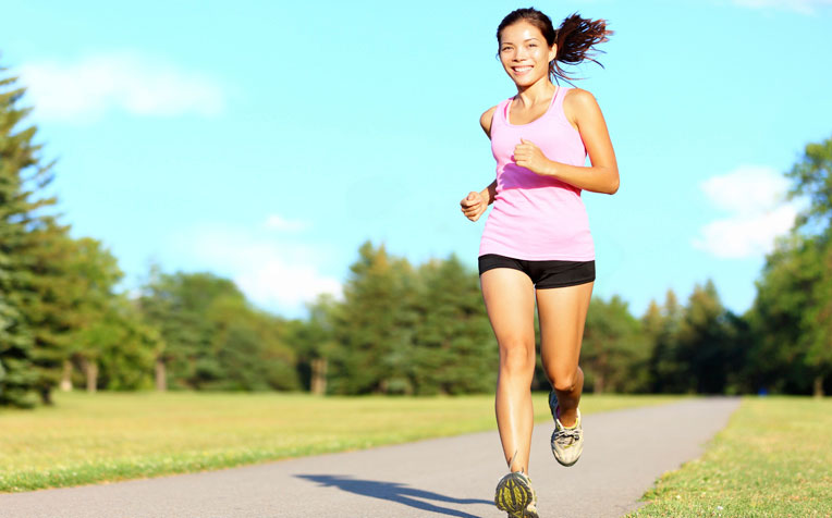 Mulher jovem correndo feliz em pista de corrida